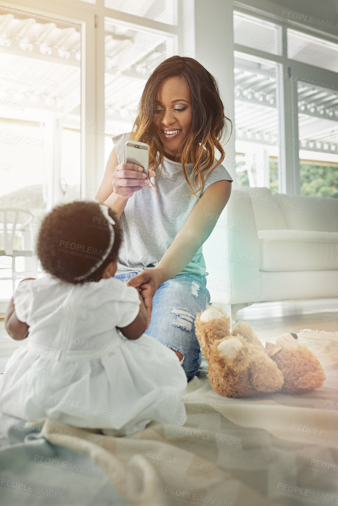 Buy stock photo Happy woman, baby and cellphone for childhood development, motor skills or bonding as family in playroom. Mother, daughter and home with pride, love and support or growth in photography for memory