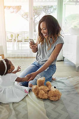 Buy stock photo Shot of a mother talking pictures of her baby daughter at home