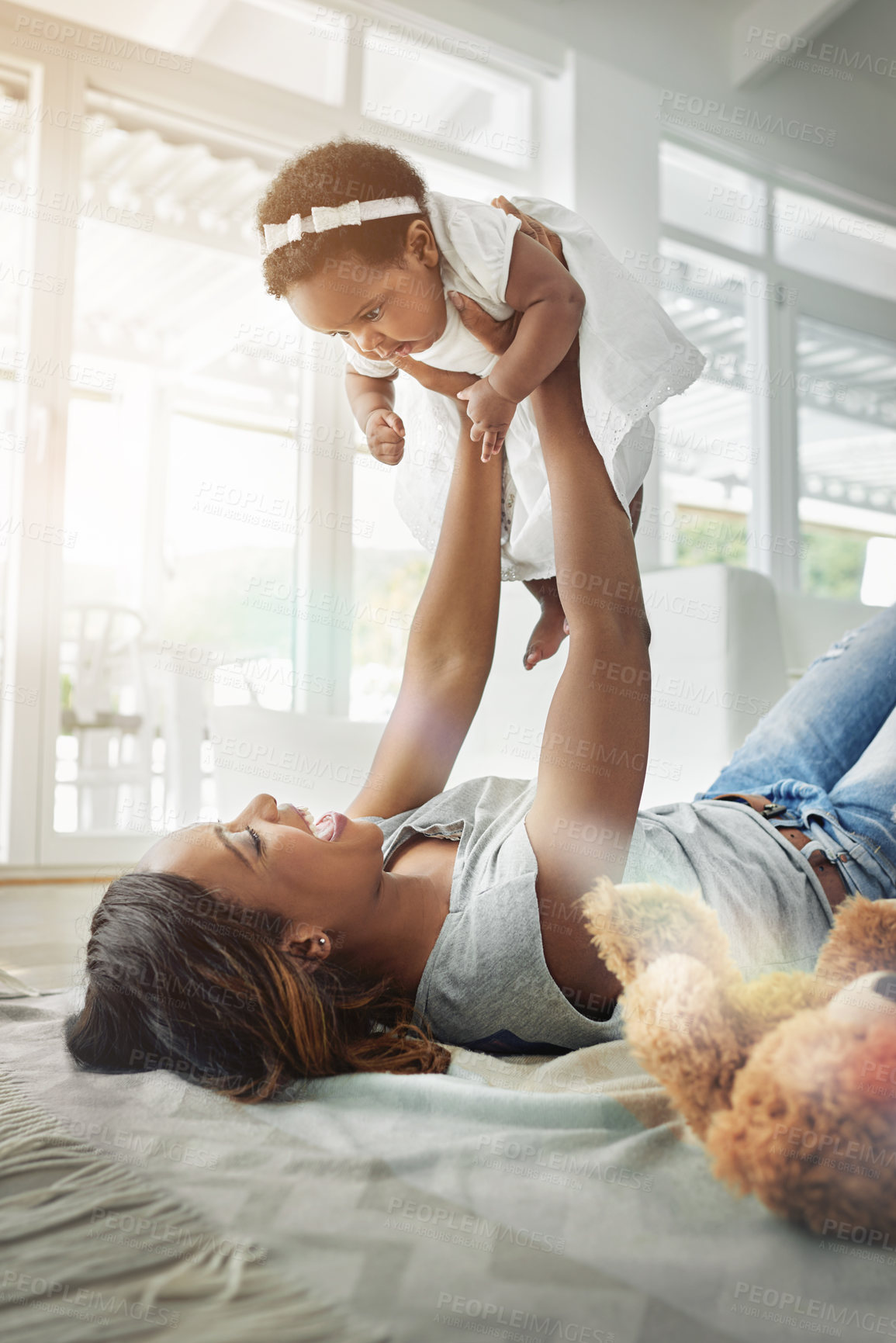 Buy stock photo Bonding, black woman and baby playing on floor with love, happiness and happy time together in living room. Smile, mother and daughter in playful embrace, laughing parent and newborn in family home.