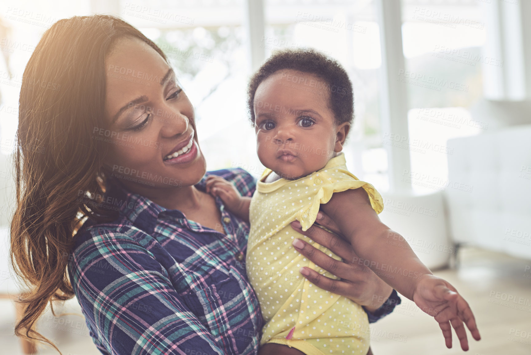 Buy stock photo Cropped shot of a young mother and her little baby girl at home