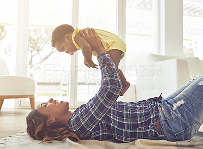 Buy stock photo Home, mama and baby on floor, playing and bonding together with happiness in lounge. Black family, single parent and kid on ground, airplane and care with woman, growth smile and child development