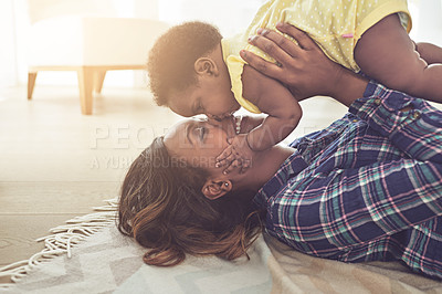 Buy stock photo Cropped shot of a young mother and her little baby girl at home