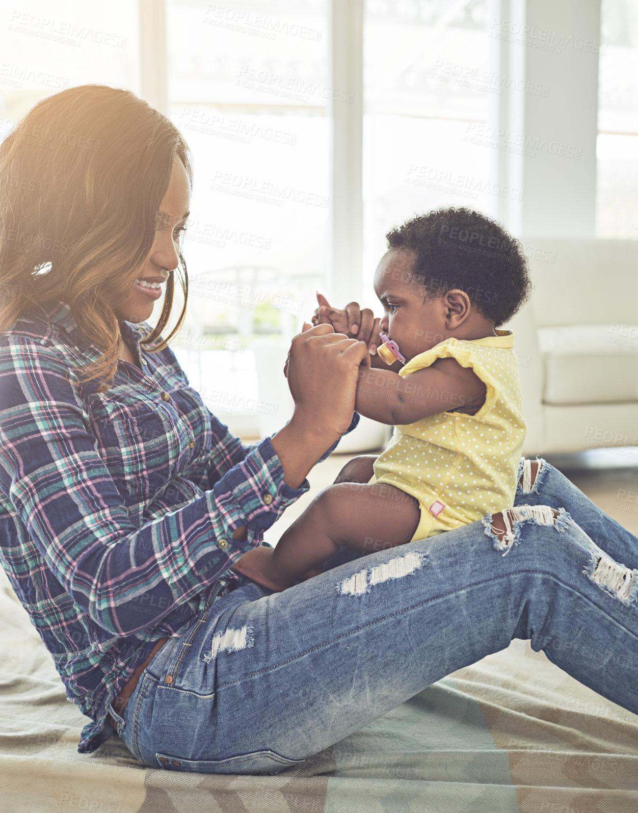 Buy stock photo Cropped shot of a young mother and her little baby girl at home