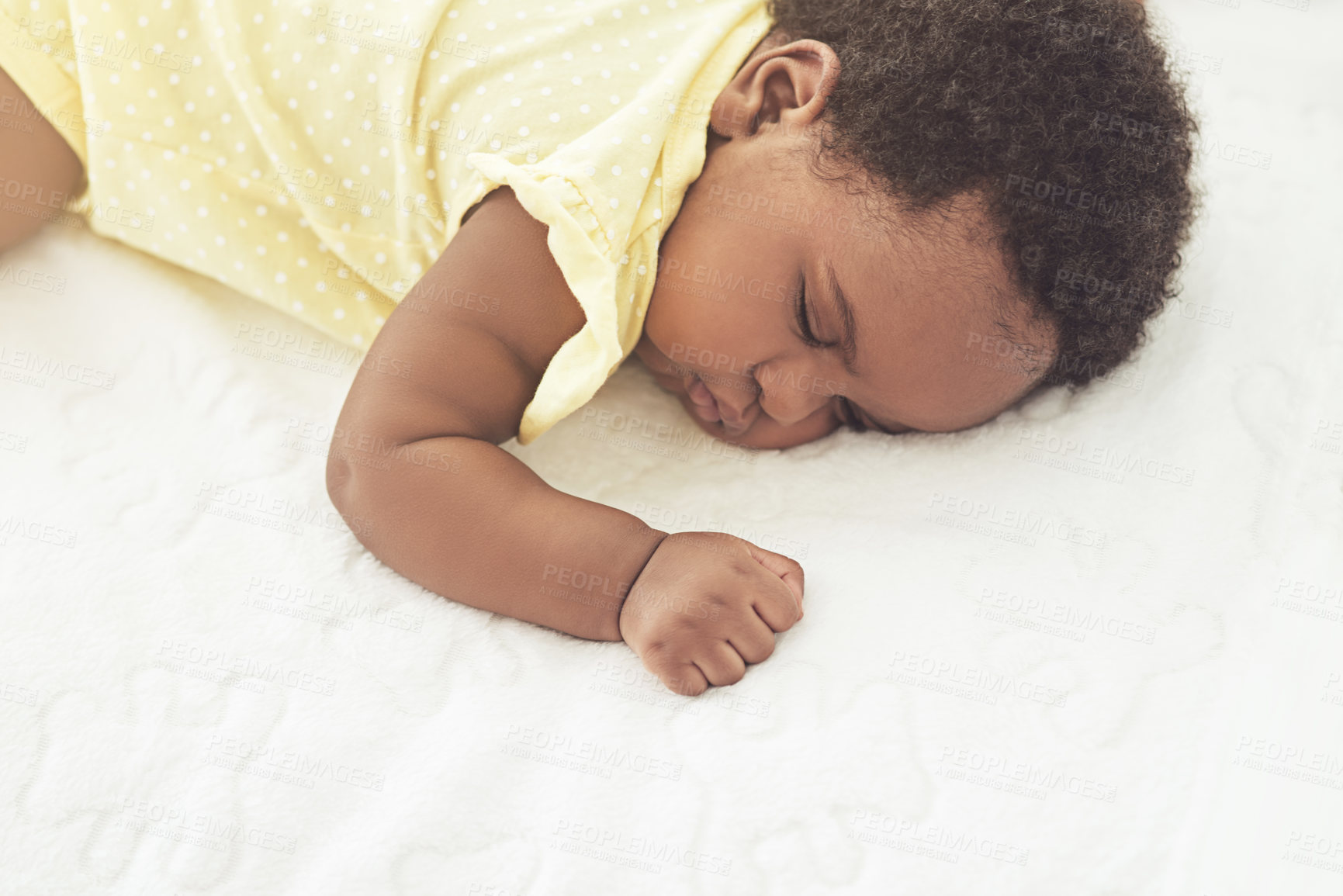 Buy stock photo Cropped shot of a baby girl asleep on a bed at home