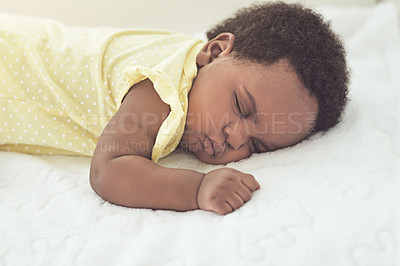 Buy stock photo Cropped shot of a baby girl asleep on a bed at home