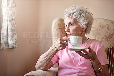 Buy stock photo Shot of a senior woman having a cup of coffee at home