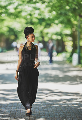 Buy stock photo Shot of an attractive young woman going for a walk outdoors