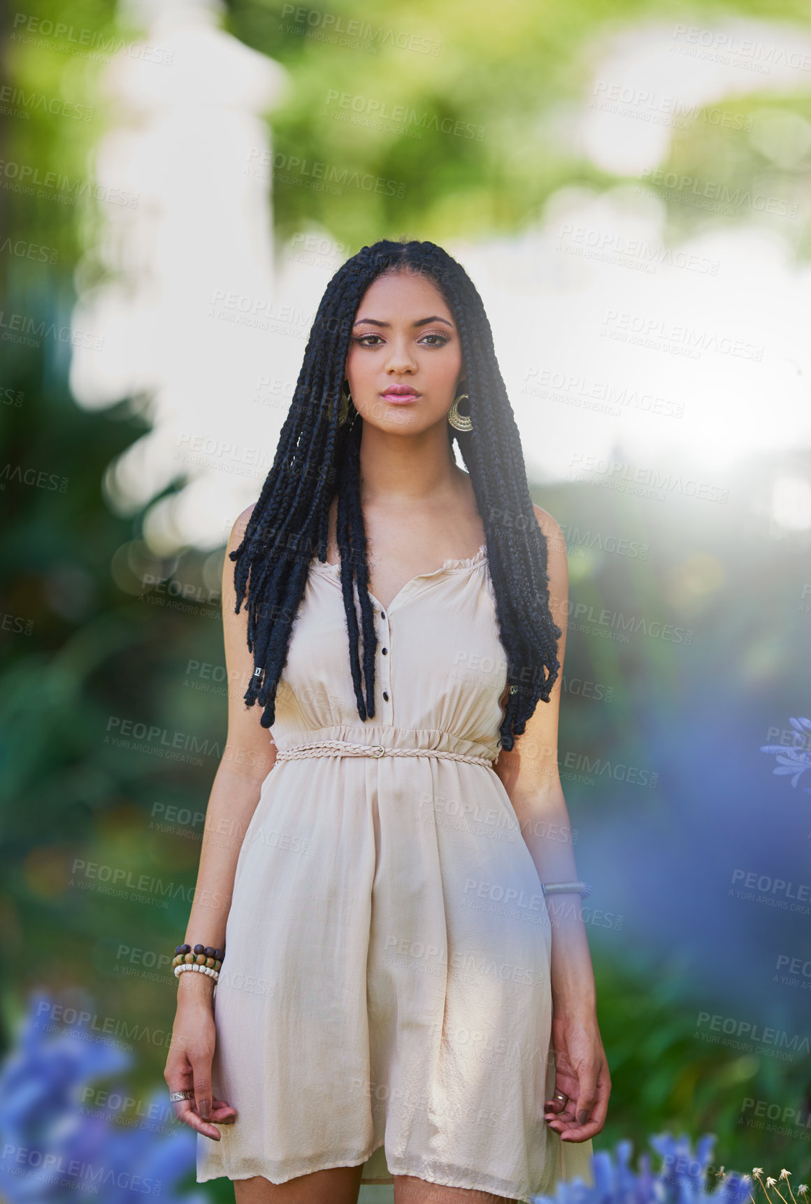 Buy stock photo Portrait of a femininely dressed young woman posing outdoors