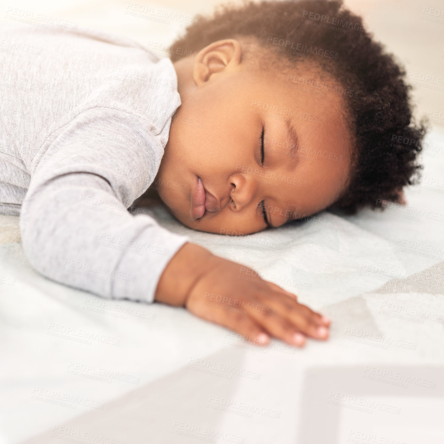 Buy stock photo Shot of a little baby boy sleeping on a bed