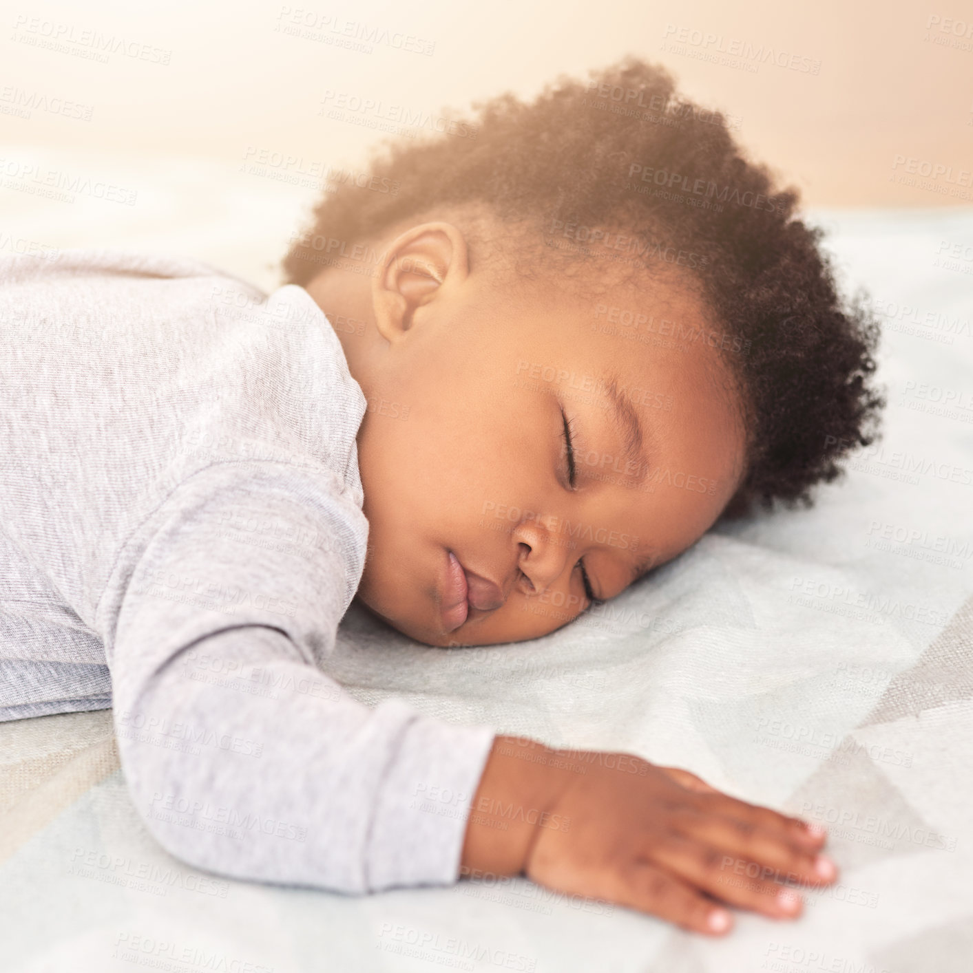 Buy stock photo Shot of a little baby boy sleeping on a bed