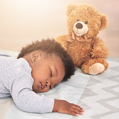 Buy stock photo Shot of a little baby boy sleeping on a bed with a teddy bear