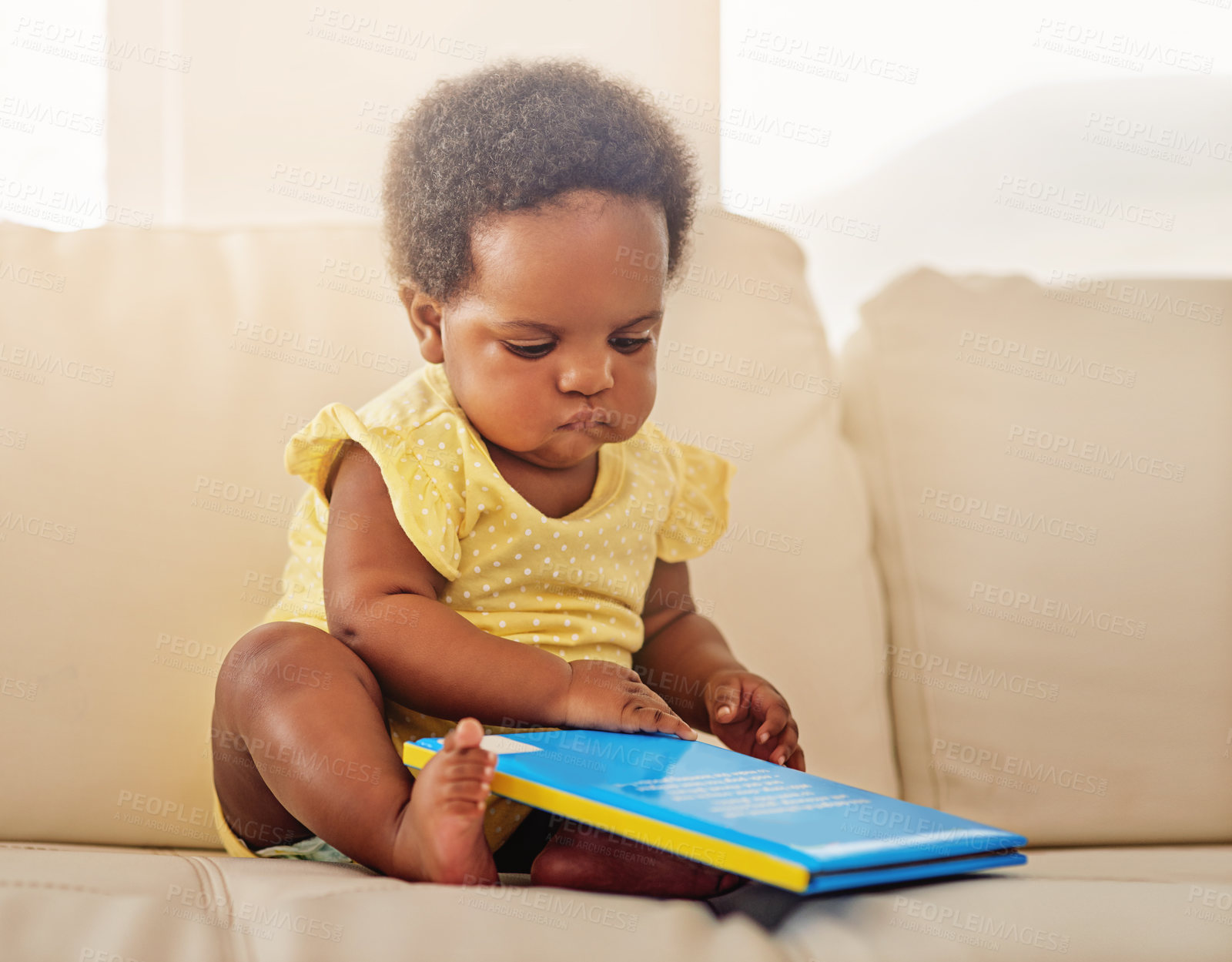 Buy stock photo Full length shot of a baby girl sitting on the sofa at home