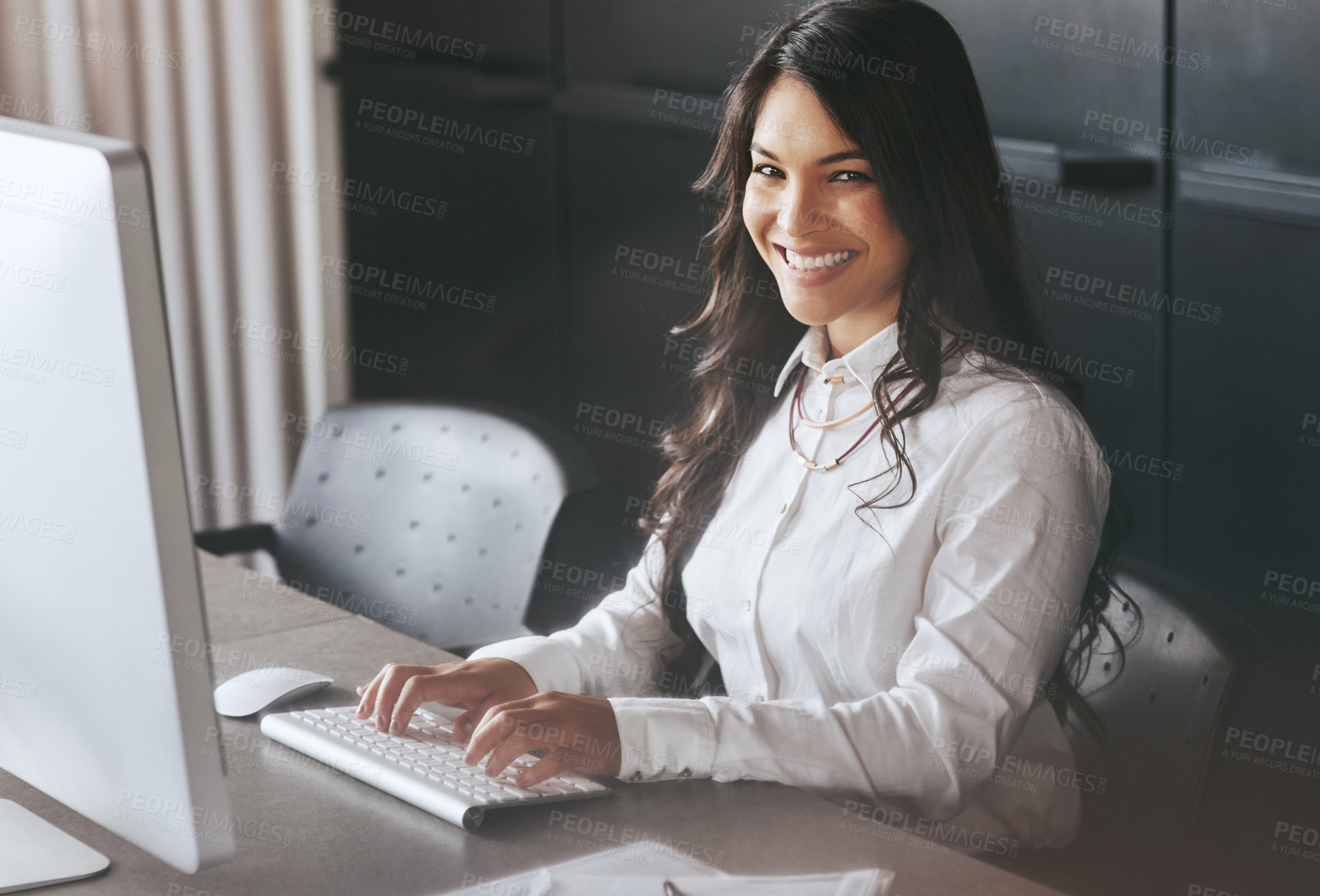 Buy stock photo Portrait of a young businesswoman working on a computer at work