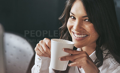 Buy stock photo Portrait of a confident young businesswoman enjoying a beverage at work