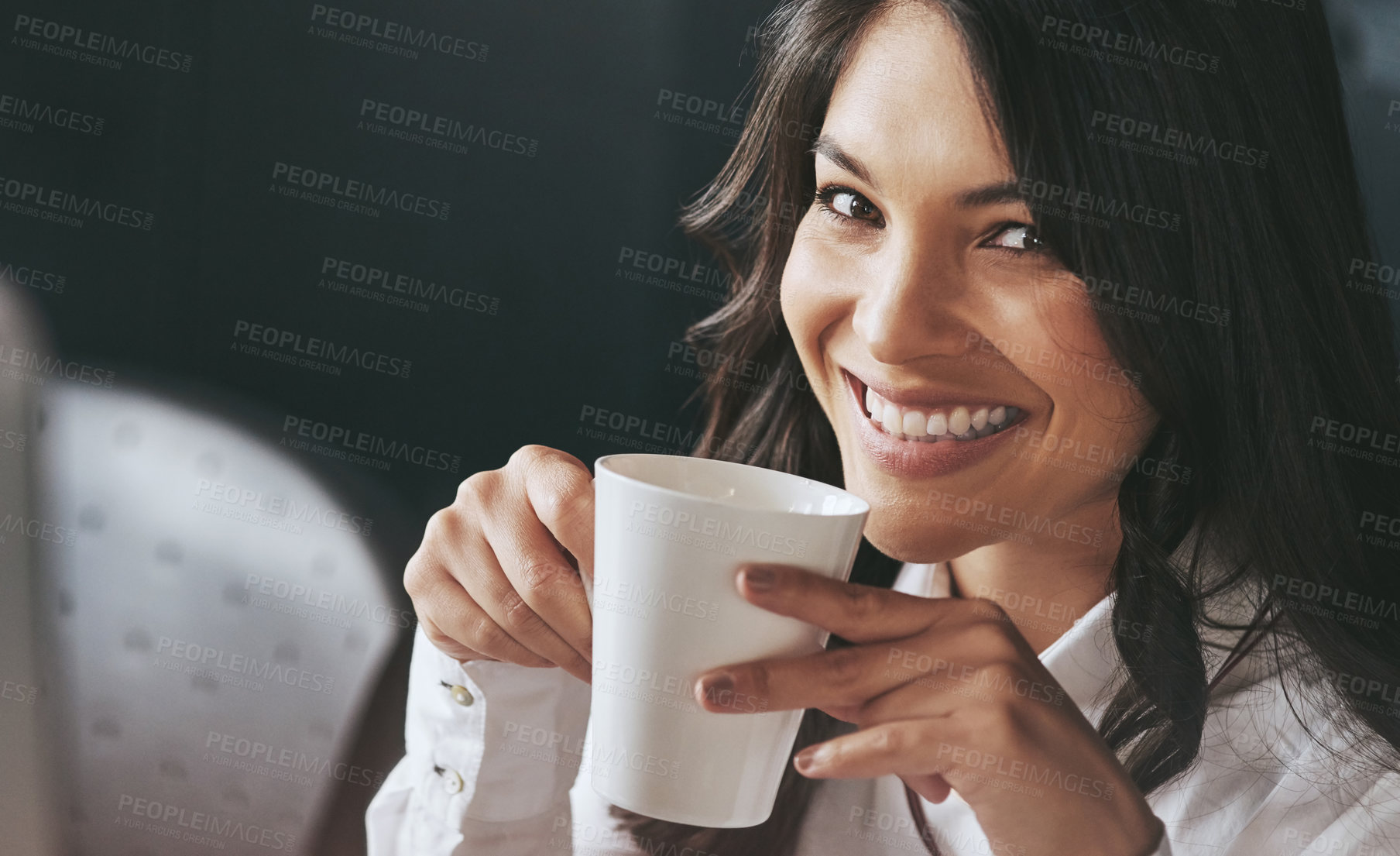 Buy stock photo Portrait of a confident young businesswoman enjoying a beverage at work