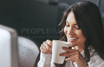 Buy stock photo Shot of a successful young businesswoman enjoying a beverage at work