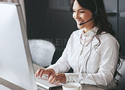Buy stock photo Shot of a friendly support agent working at a desk in an office