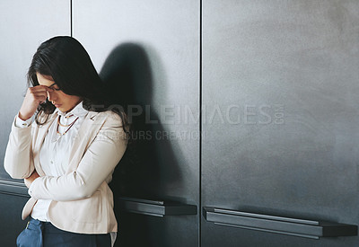 Buy stock photo Shot of a young businesswoman looking stressed at work