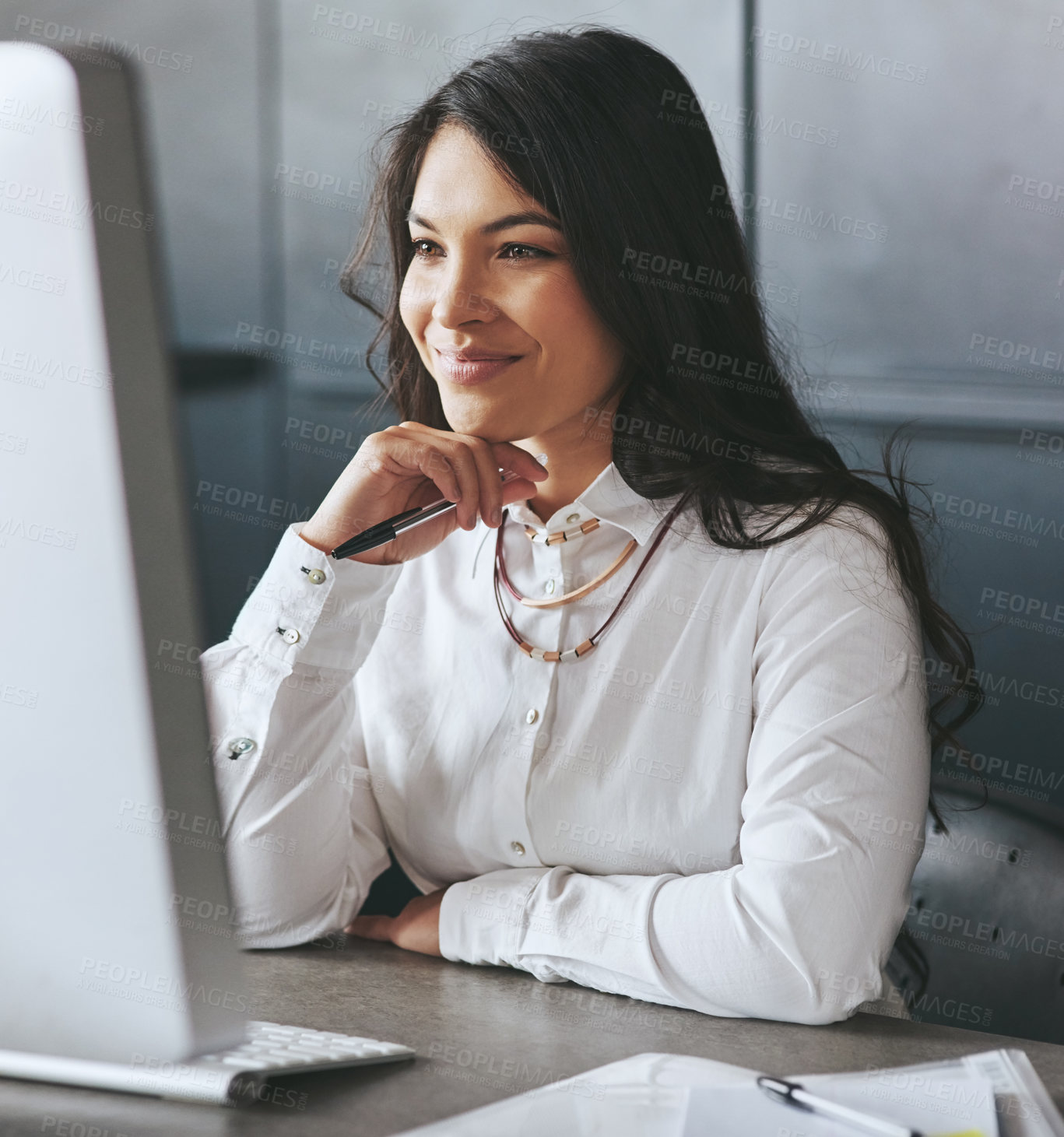 Buy stock photo Shot of a young businesswoman working on a computer at work