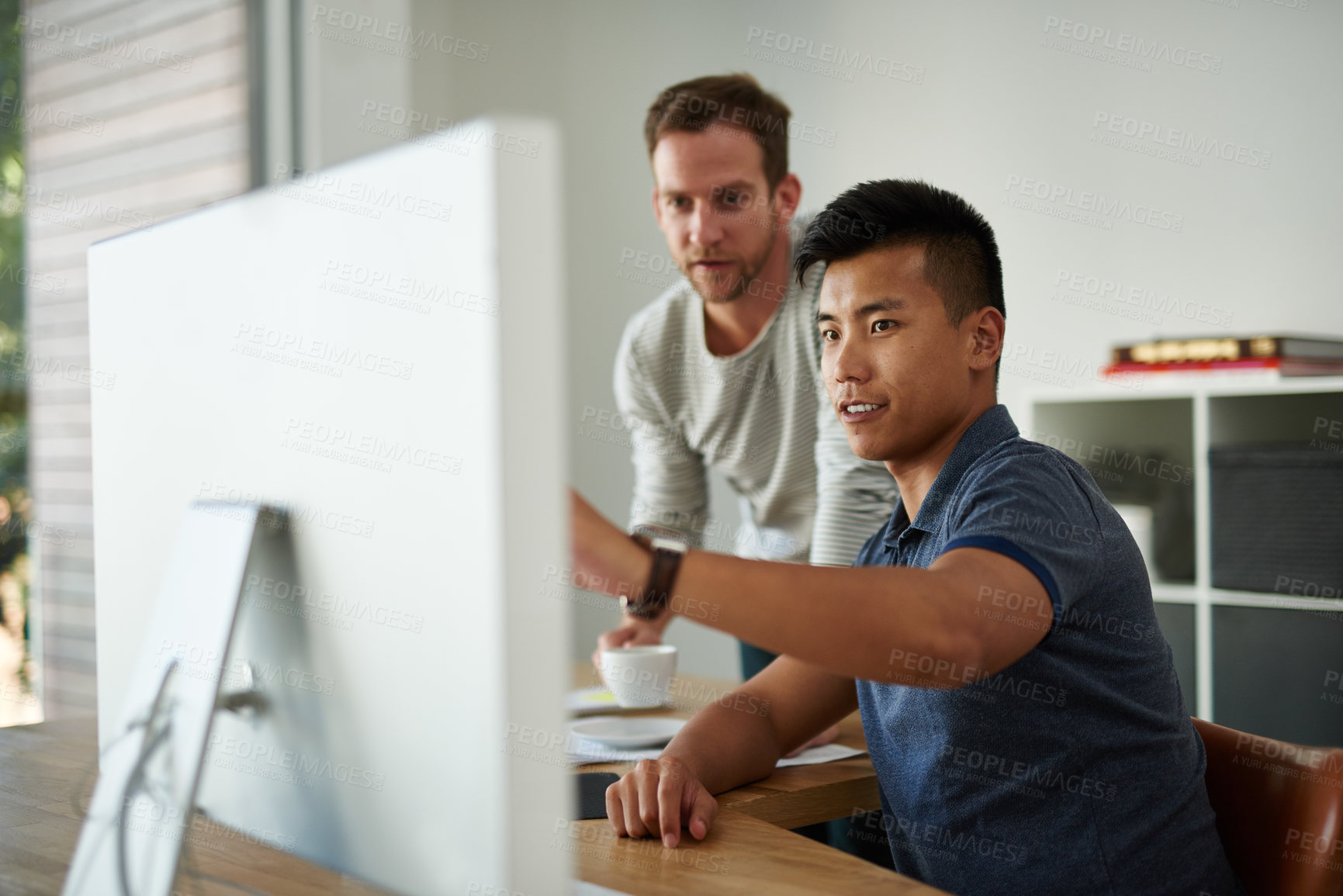 Buy stock photo Cropped shot of two designers working together on a project in an office