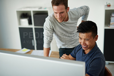 Buy stock photo High angle shot of two designers working together on a project in an office