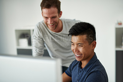Buy stock photo High angle shot of two designers working together on a project in an office
