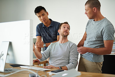 Buy stock photo Cropped shot of three designers working together on a project in an office
