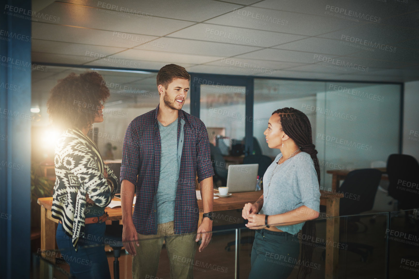 Buy stock photo Shot of colleagues talking in a modern office