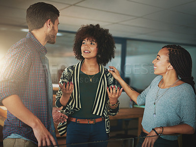 Buy stock photo Shot of colleagues talking in a modern office