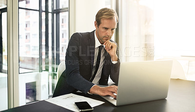 Buy stock photo Shot of a businessman using his laptop