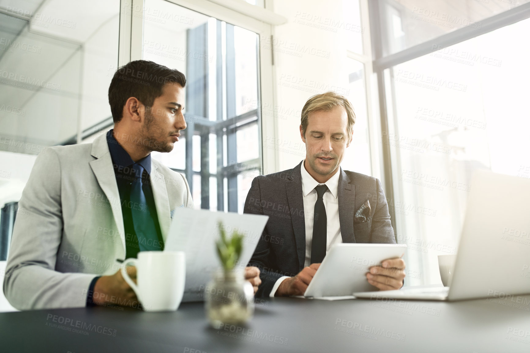 Buy stock photo Shot of two businesspeople having a discussion in an office