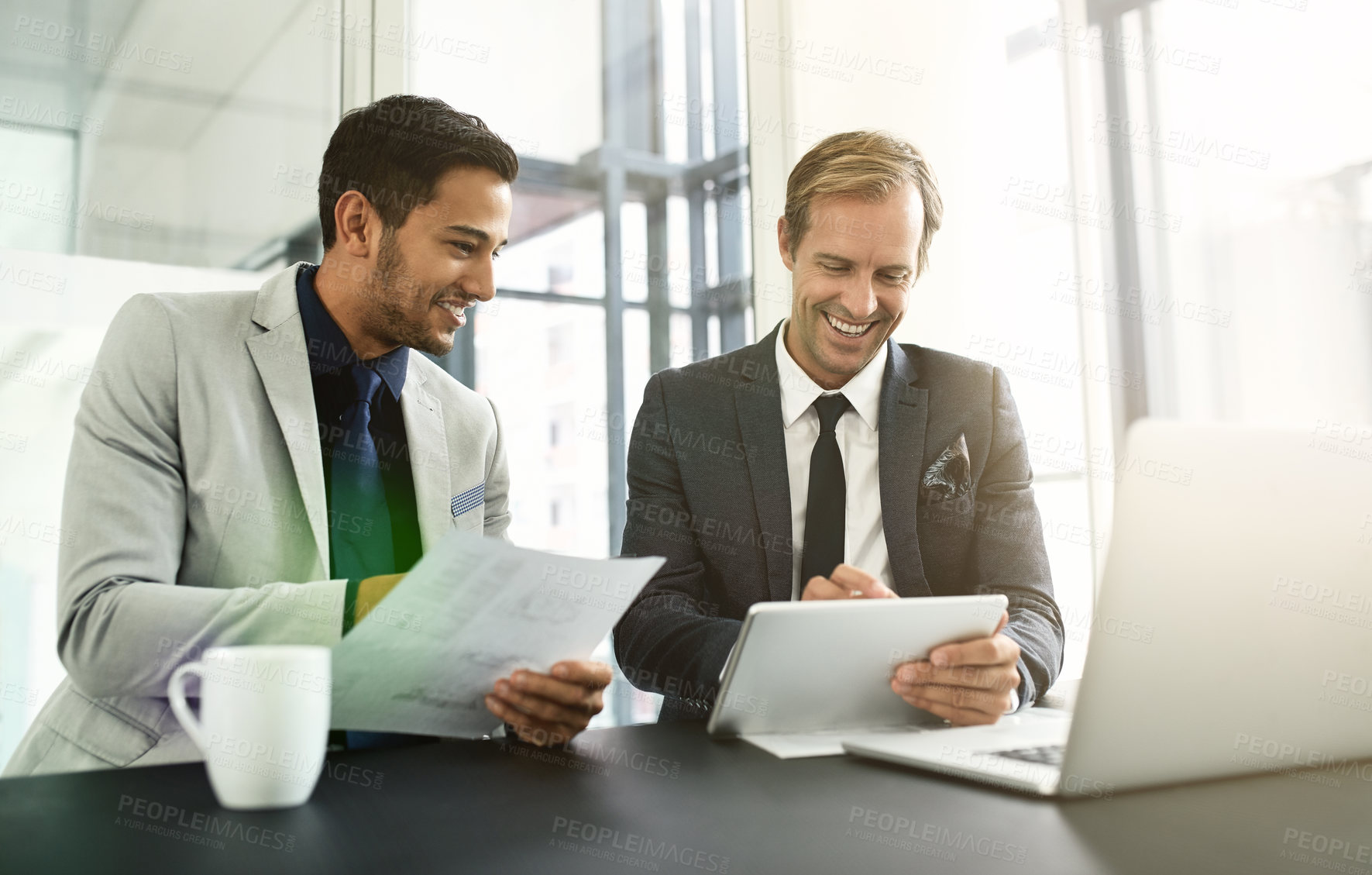 Buy stock photo Shot of two businesspeople having a discussion in an office