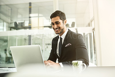 Buy stock photo Shot of a businessman using his laptop