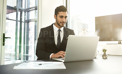 Buy stock photo Shot of a businessman using his laptop