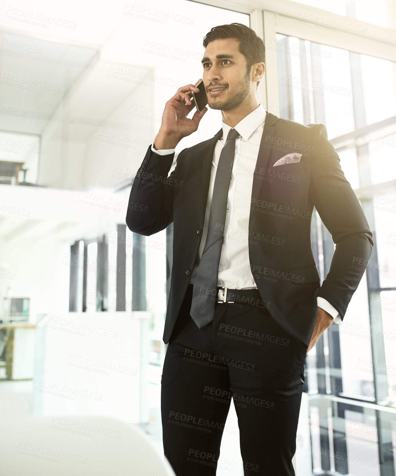 Buy stock photo Shot of a businessman talking on his cellphone in an office