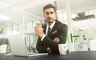 Buy stock photo Portrait of a businessman sitting in an office with his laptop in front of him