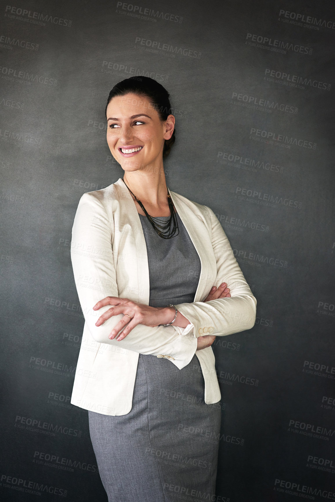 Buy stock photo Studio shot of a businesswoman standing with her arms folded against a grey background