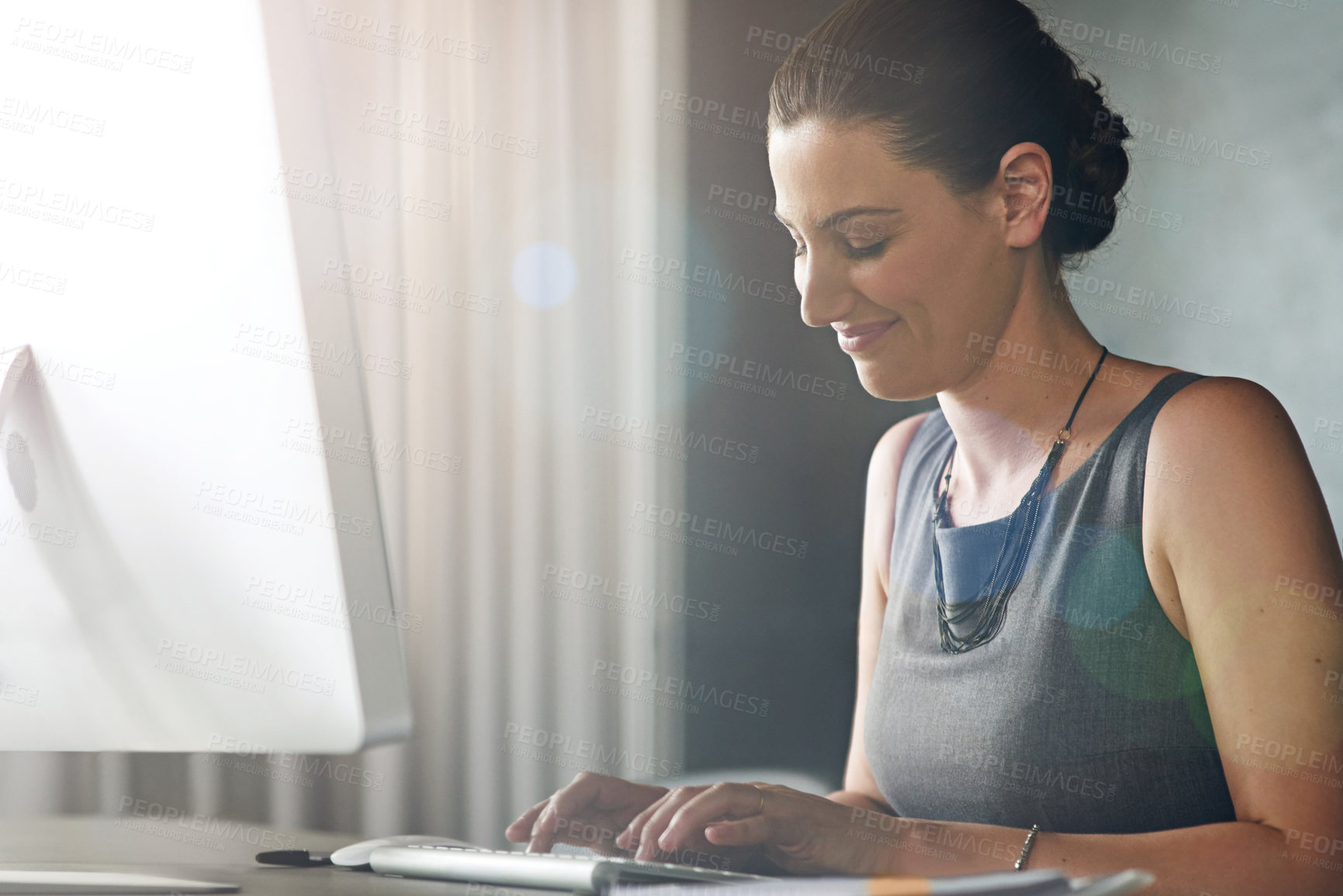 Buy stock photo Cropped shot of a businesswoman working on her pc in the office