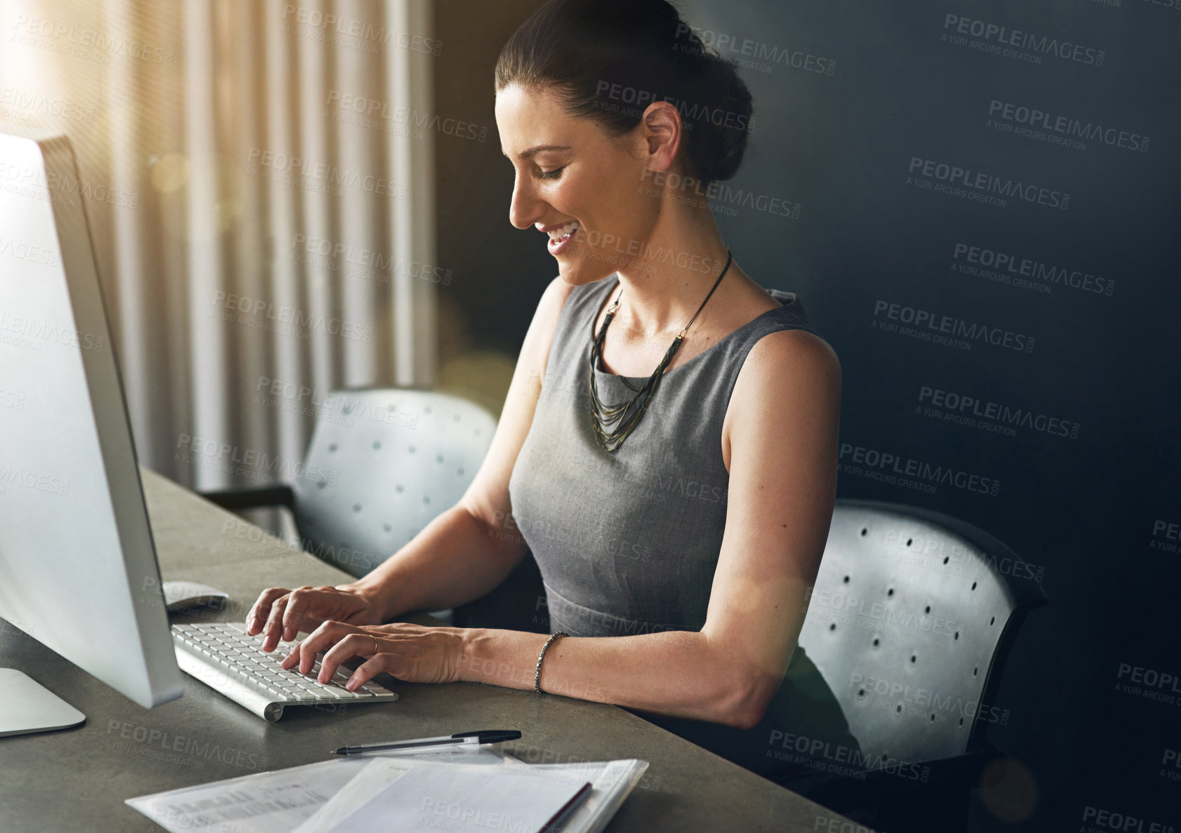 Buy stock photo Cropped shot of a businesswoman working on her pc in the office