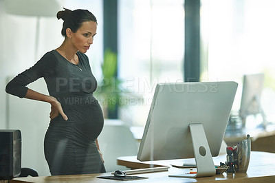 Buy stock photo Shot of a pregnant businesswoman working in an office