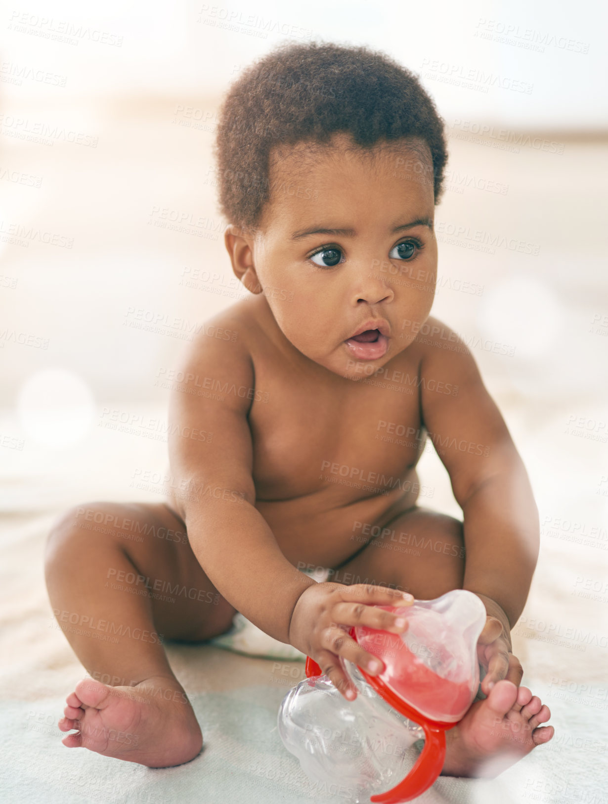 Buy stock photo Kids, baby and black girl with a bottle sitting on a blanket on a home floor for child development. Children, cute and curious with a thirsty newborn infant learning or growing alone in a house