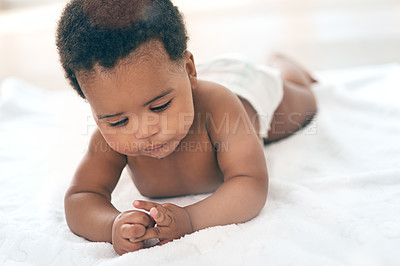 Buy stock photo Baby, children and lying with a black baby in the home, blanket on the floor for child development or growth. Kids, cute and innocent with a newborn infant comfortable on a duvet in a house alone