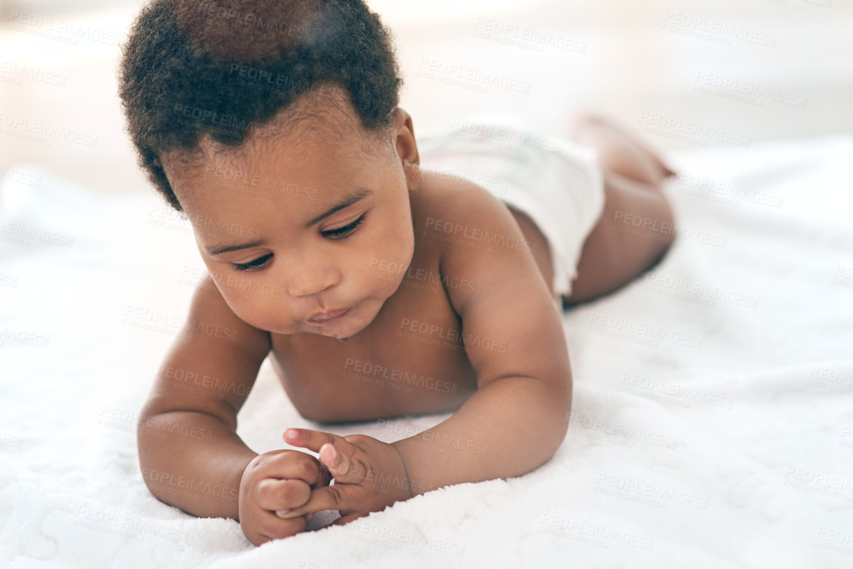 Buy stock photo Baby, children and lying with a black baby in the home, blanket on the floor for child development or growth. Kids, cute and innocent with a newborn infant comfortable on a duvet in a house alone