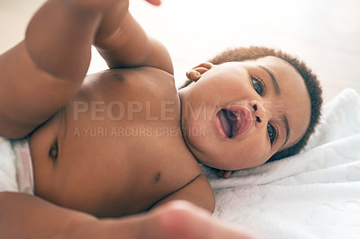 Buy stock photo Kids, black baby and a girl lying on a towel in her home for growth or child development from above. Children, bedroom and cute with a newborn infant female resting on a bed to relax in a house