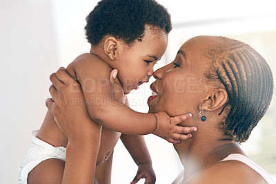 Buy stock photo Relax, touch and nose with mother and baby for bonding, affectionate and connection in family home. Kindness, happiness and smile with black woman holding child for positive, growth and support