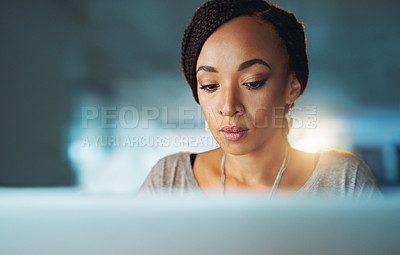Buy stock photo Cropped shot of a young woman using her laptop while working late in her office