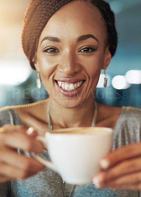 Buy stock photo Cropped portrait of a young woman drinking coffee while working late in her office