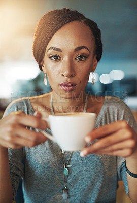 Buy stock photo Cropped portrait of a young woman drinking coffee while working late in her office