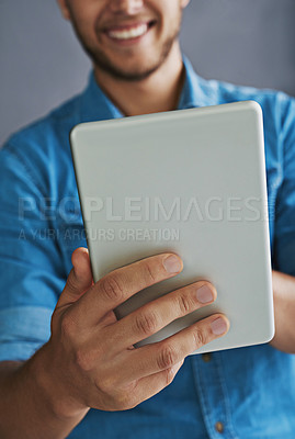 Buy stock photo Studio shot of a young man  using a digital tablet
