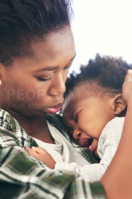 Buy stock photo Shot of a mother cradling her crying baby boy